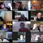 Screenshot from Zoom call, participants with fists raised.